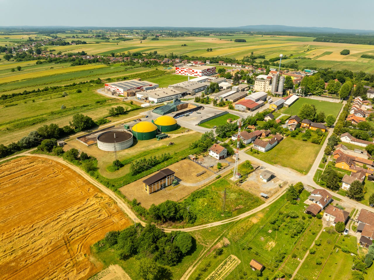 Aerial shot of Hercegovac, Croatia, showing industrial and agricultural landscape.